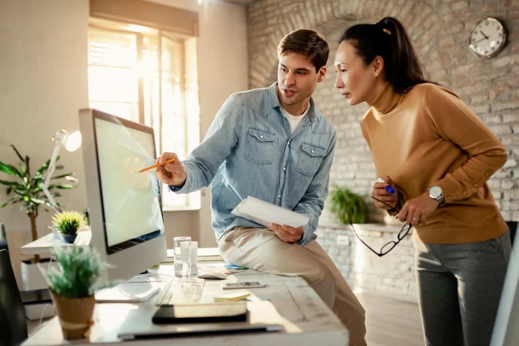 Couple and contractor reviewing a home design on-screen—Truxtun client consultation session