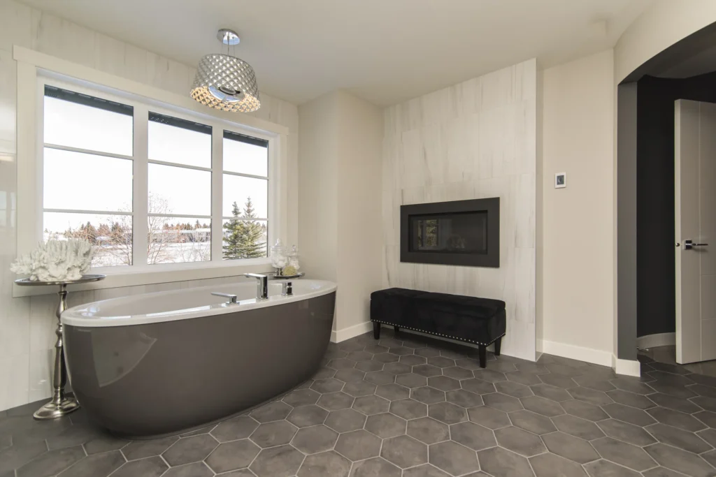 Minimalist bathroom with soaking tub, fireplace, and large windows—Truxtun custom bathroom design